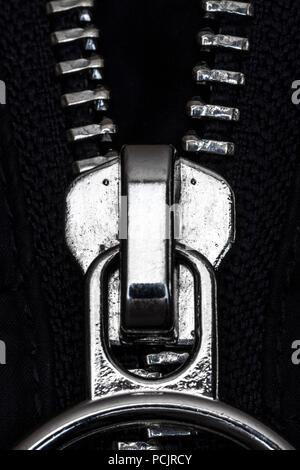 Chromed zipper lock on a blue jacket close-up. Stock Photo