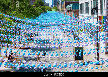 Montreal, Canada - June, 2018. Iconic colorful rainbow balls hanging over the gay village in Sainte-Catherine street of montreal, quebec, canada. Edit Stock Photo