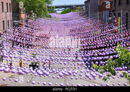 Montreal, Canada - June, 2018. Iconic pink rainbow balls hanging over the gay village in Sainte-Catherine street of montreal, quebec, canada. Editoria Stock Photo