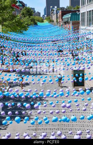 Montreal, Canada - June, 2018. Iconic colorful rainbow balls hanging over the gay village in Sainte-Catherine street of montreal, quebec, canada. Edit Stock Photo