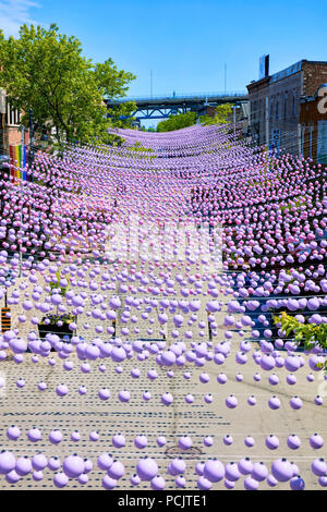 Montreal, Canada - June, 2018. Iconic pink rainbow balls hanging over the gay village in Sainte-Catherine street of Montreal, Quebec, Canada. Editoria Stock Photo