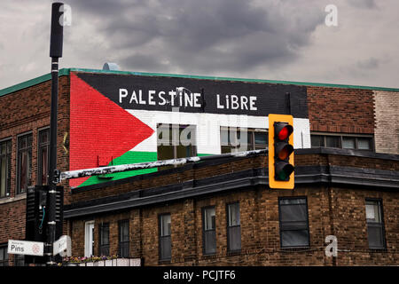 Palestine flag and free Palestine (palestine libre) slogan in French painted on the brick walls of a building in Montreal, Quebec, Canada. Stock Photo