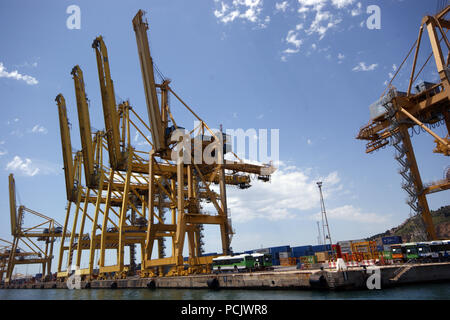Dockside Container Ship Yellow Large Cranes at the docks in Barcelona Port Stock Photo