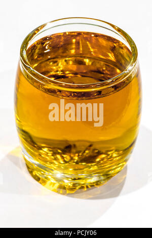 A shot of a strong alcoholic beverage on a white background close-up. Stock Photo