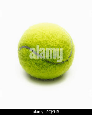Bright green tennis ball on a white background close-up. Stock Photo