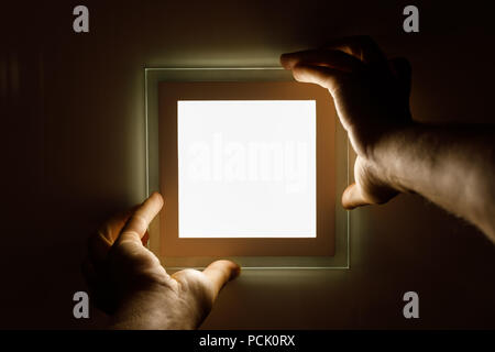 electrician installs an LED light Stock Photo