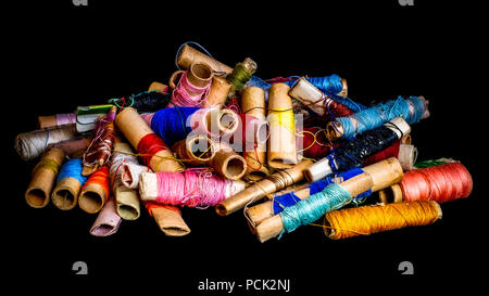 Pile of used colorful spools of thread tailo Stock Photo