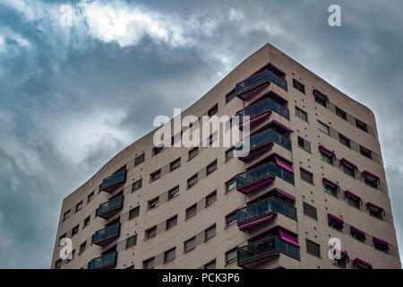 Malaga, Spain - March 10, 2018. Block of flats with dark clouds before havy rain storm Stock Photo