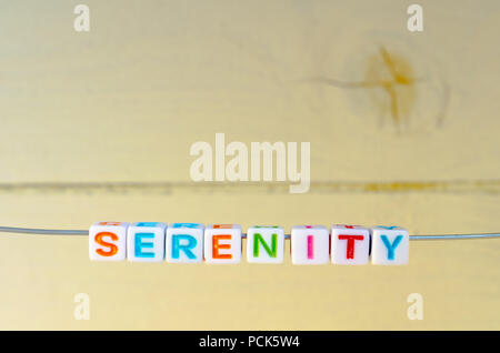 A Studio Photograph of Alphabetical Beads Suspended on a Wire Spelling 'Serenity' Stock Photo