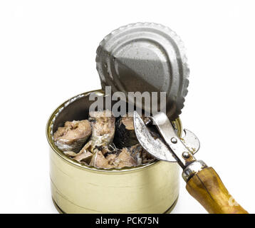 Open tin can with fish and can opener on a white background close-up. Stock Photo
