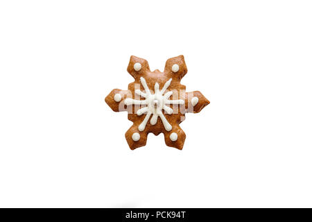 Isolated on white background a traditional Christmas gingerbread cookie in the form of a snowflake. Stock Photo