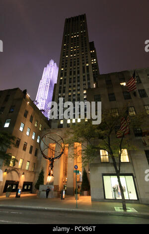 Night view of the Atlas sculpture holding the world in his hands in front of the Rockefeller Center in Manhattan, New York City, NY, United States Stock Photo