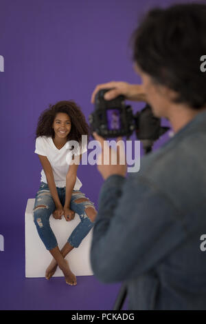 Photographer taking picture of model in studio Stock Photo