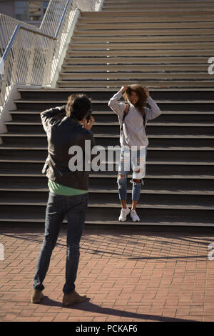 Photographer taking pictures of a model in street Stock Photo