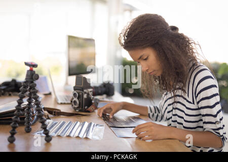 Photographer working at desk in the photo studio Stock Photo