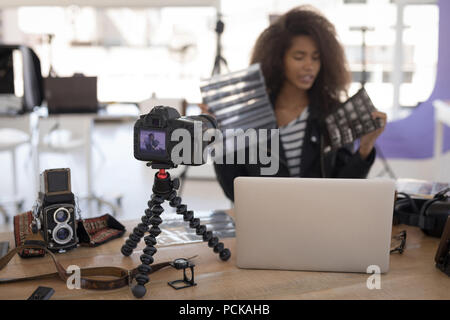 Pretty photographer working at laptop Stock Photo