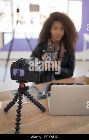 Pretty photographer working at laptop Stock Photo