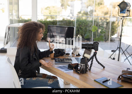 Pretty photographer working at laptop Stock Photo