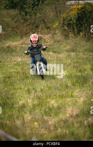 Kid riding bike in a helmet. Child riding bike in protective helmet