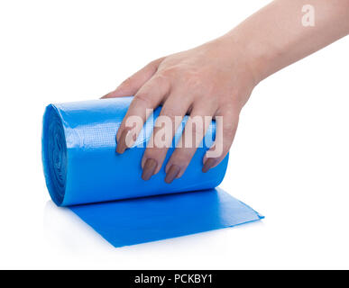 roll of garbage bags in a hand on a white isolated background Stock Photo