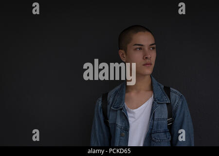 Young man leaning against wall Stock Photo