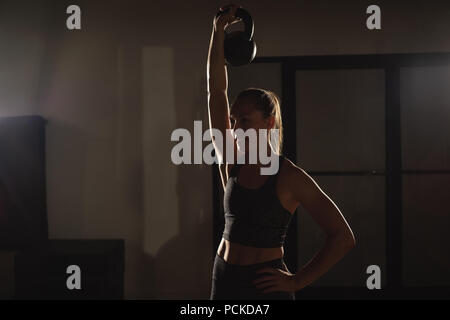 Woman doing exercises with kettlebell Stock Photo