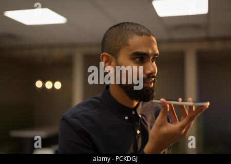 Male executive talking on mobile phone Stock Photo