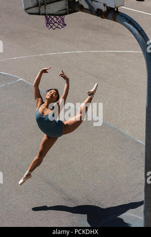 Female ballet dancer dancing in the basketball court Stock Photo