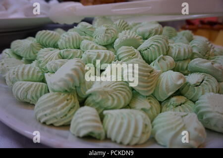 Sweet pastry marshmallows on a white plate, sweets in the hotel restaurant. Stock Photo