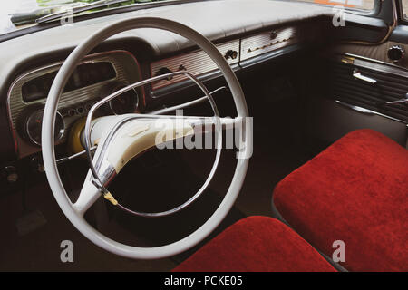 Interior of a vintage opel car with red seats. Stock Photo