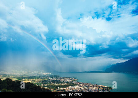 rainbow over Lausanne seen from the hills Stock Photo