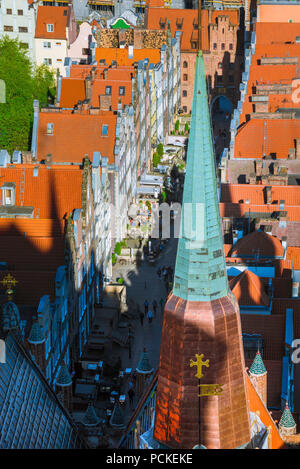 Poland Baltic city, aerial view of typical tall terraced houses in Ulica Mariacka in Gdansk Old Town with a spire of St Mary's Church in foreground. Stock Photo