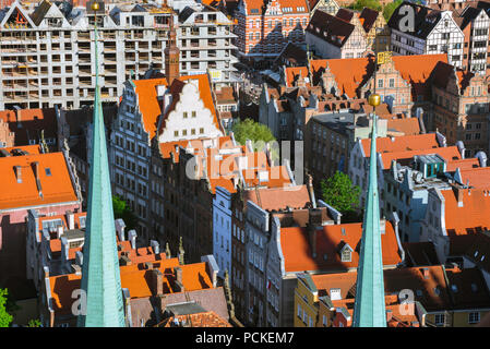 Gdansk houses, aerial view of typical terraced houses in the Old Town area Gdansk, with the spires of St Mary's Church in the foreground, Poland. Stock Photo
