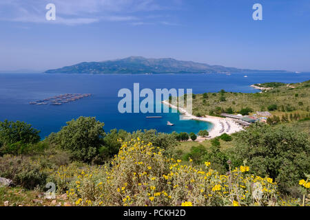 Coast with beach Gjiri i Hartes, behind the Greek island of Corfu, National Park Butrint, between Ksamil and Saranda, Sarandë Stock Photo