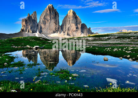 the-three-peaks-of-lavaredo-are-reflected-in-lake-antorno-at-sunrise