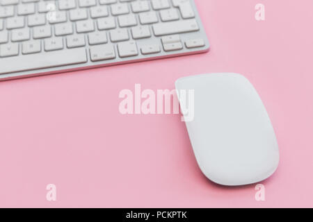 Computer keyboard mouse on pink background Stock Photo