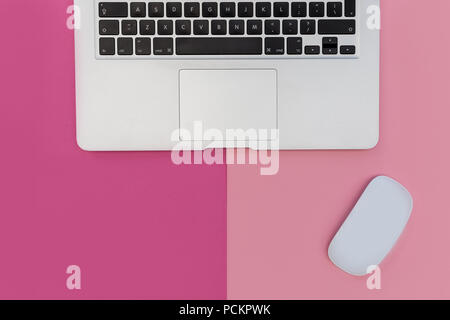 Laptop computer mouse on bright pink background Stock Photo
