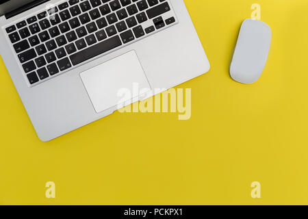 Laptop computer mouse on bright yellow background Stock Photo