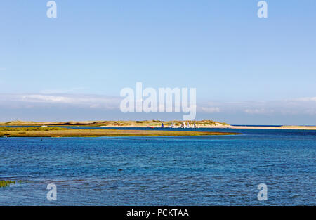 A view over Overy Creek to Scolt Head Island on the North Norfolk coast at Burnham Overy Staithe, Norfolk, England, United Kingdom, Europe. Stock Photo