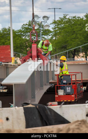 Detroit, Michigan - Workers set a girder in place while rebuilding a bridge on Interstate 94. Stock Photo