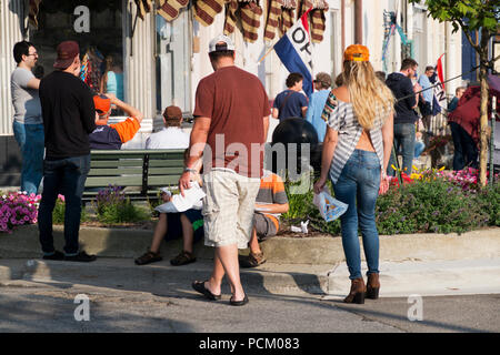 Costumes, mode of dress, or style of clothing at annual Cruz-In parade for antique and vintage vehicles in downtown Montague, Michigan, USA. Stock Photo