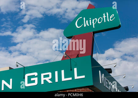 A logo sign outside of the first Chipotle fast casual restaurant location in Denver, Colorado, on July 22, 2018. Stock Photo