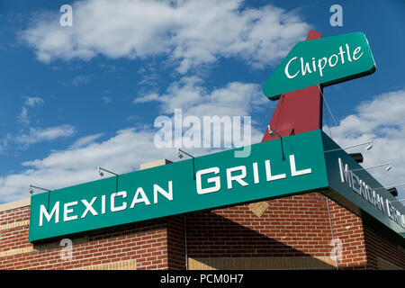 A logo sign outside of the first Chipotle fast casual restaurant location in Denver, Colorado, on July 22, 2018. Stock Photo