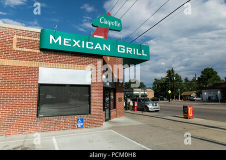 A logo sign outside of the first Chipotle fast casual restaurant location in Denver, Colorado, on July 22, 2018. Stock Photo