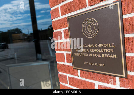 A logo sign outside of the first Chipotle fast casual restaurant location in Denver, Colorado, on July 22, 2018. Stock Photo