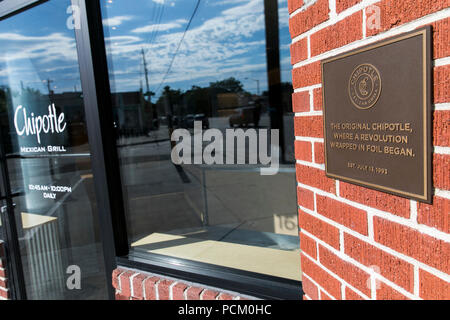 A logo sign outside of the first Chipotle fast casual restaurant location in Denver, Colorado, on July 22, 2018. Stock Photo