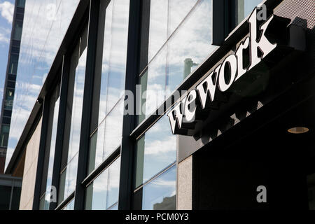 A logo sign outside of a WeWork coworking office location in Denver, Colorado, on July 22, 2018. Stock Photo