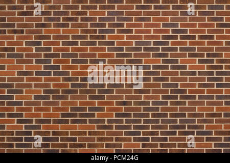 Colorful traditional brown clay brick wall background in varying shades of brown Stock Photo