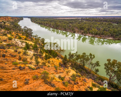 Gum trees reflecting beautifully in Murray River Stock Photo