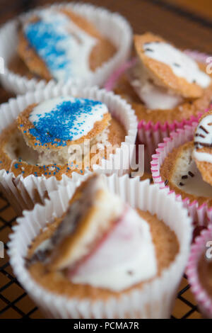 Homemade vanilla cupcakes with a chocolate coated strawberry and icing. Stock Photo